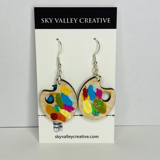 Solid maple earrings in summer colors. Front view on card.
