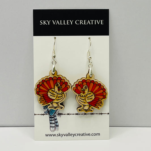 Turkey-shaped laser-cut and hand-painted earrings on a 'Sky Valley Creative' branded card.