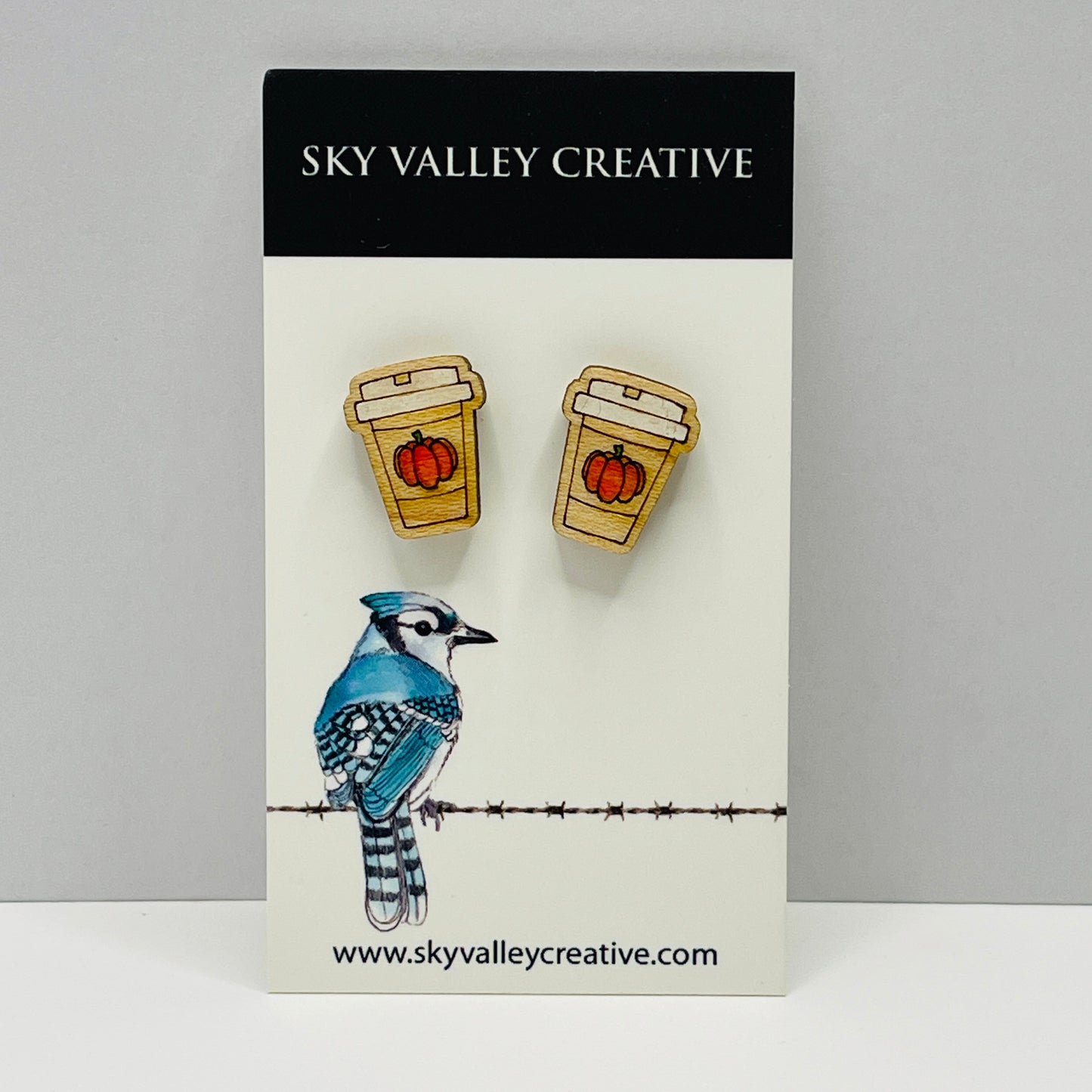Pumpkin spice latte post earrings with little pumpkins on a display, branded 'Sky Valley Creative'.