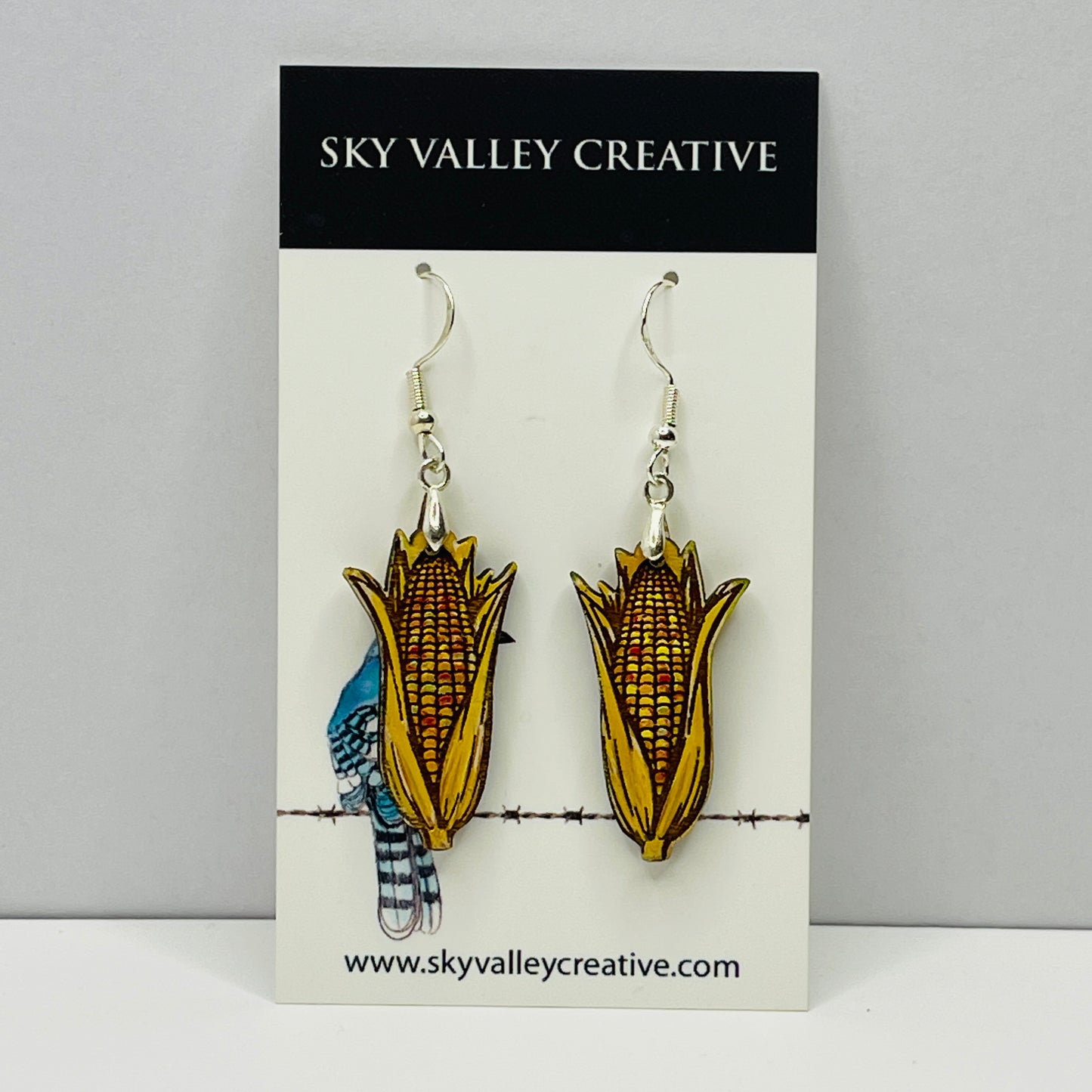 Indian corn maple dangle earrings on a 'Sky Valley Creative' branded card.