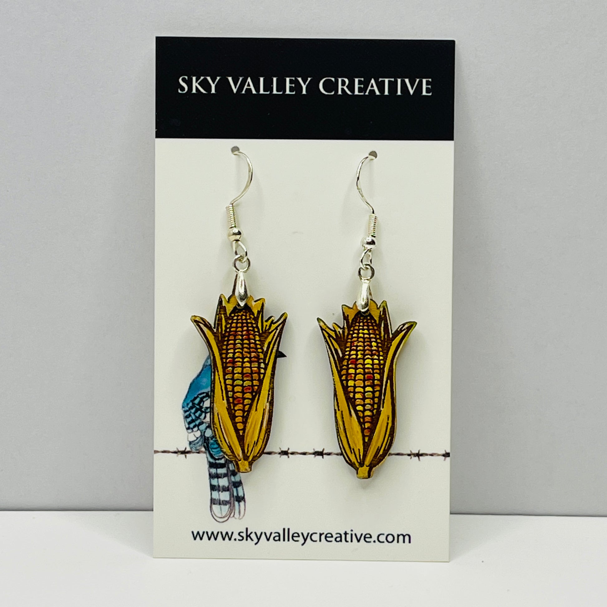 Indian corn maple dangle earrings on a 'Sky Valley Creative' branded card.