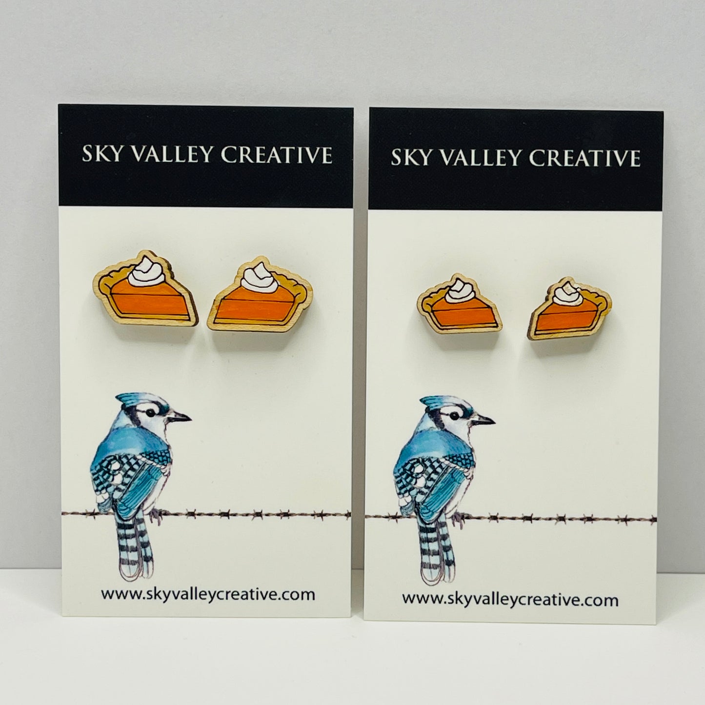 Two pairs of earrings on display with 'Sky Valley Creative' branding. Regular size and small size.
