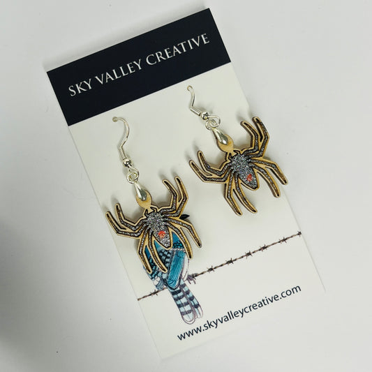Spider-shaped earrings on a 'Sky Valley Creative' branded card.