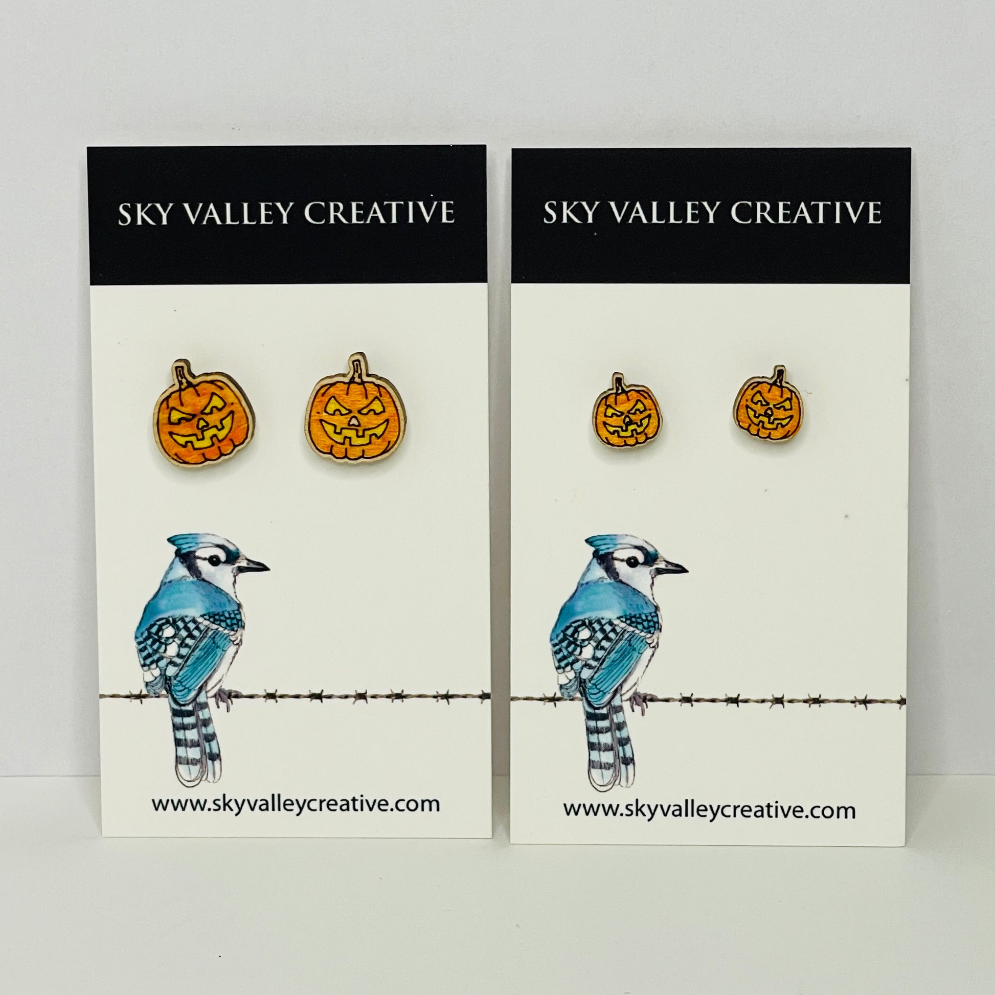 Two cards from Sky Valley Creative with Jack-o-lantern Halloween earrings in regular and small sizes.